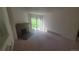 Bright living room featuring a cozy brick fireplace and sliding glass doors to the outside at 14806 E 2Nd Ave Ave # 105G, Aurora, CO 80011