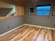Attic or bonus room featuring wooden floors and window at 26212 Center Dr, Kittredge, CO 80457