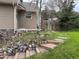 Landscaped backyard featuring stone steps, native grasses, and wooden fence at 26212 Center Dr, Kittredge, CO 80457