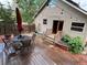 Backyard features string lights, wood deck with table and chairs, and an open backyard at 26212 Center Dr, Kittredge, CO 80457