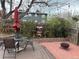 Backyard with patio dining and fire pit, complete with garden and directional sign décor at 26212 Center Dr, Kittredge, CO 80457