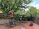 Charming backyard with string lights, wood deck, brick patio, and fire pit at 26212 Center Dr, Kittredge, CO 80457