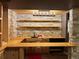Finished basement wet bar features stone accents and wood shelving at 26212 Center Dr, Kittredge, CO 80457