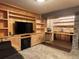 Finished basement featuring built-in shelving, an electric fireplace, and a stone-look wet bar at 26212 Center Dr, Kittredge, CO 80457