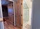 Bathroom featuring glass walk-in shower and wooden doors to other rooms at 26212 Center Dr, Kittredge, CO 80457