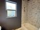 Modern bathroom featuring a shower/tub combo, natural light and mosaic shower tile at 26212 Center Dr, Kittredge, CO 80457