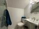 Cozy bathroom featuring a glass shower, toilet, and pedestal sink, combining functionality with style at 26212 Center Dr, Kittredge, CO 80457