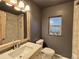 Modern bathroom with patterned shower tile, neutral color palette and modern fixtures at 26212 Center Dr, Kittredge, CO 80457