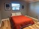 Bedroom with wood floors and orange bedding at 26212 Center Dr, Kittredge, CO 80457