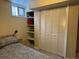 Bedroom with large closet, shelves, window, and plush bedding at 26212 Center Dr, Kittredge, CO 80457