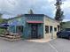 Charming coffee shop exterior with outdoor seating, colorful murals, and a welcoming ambiance at 26212 Center Dr, Kittredge, CO 80457