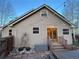 Charming home exterior featuring a cozy patio with string lights and stone landscaping accents at 26212 Center Dr, Kittredge, CO 80457
