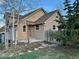Charming home with a tan exterior, complemented by trees and stone details at 26212 Center Dr, Kittredge, CO 80457