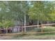 Exterior view of home with a fence and trees at 26212 Center Dr, Kittredge, CO 80457