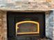 Close-up of the fireplace with stone surround and country-style accents at 26212 Center Dr, Kittredge, CO 80457