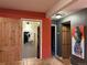 View of hallway with beautiful artwork, neutral toned walls, and wooden doors at 26212 Center Dr, Kittredge, CO 80457