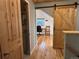 Hallway with wooden floors leads to office space separated by a wooden barn door at 26212 Center Dr, Kittredge, CO 80457