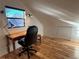 Bright office space features a wooden desk, chair, and natural light at 26212 Center Dr, Kittredge, CO 80457