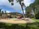 Community playground featuring swings, slides, and climbing structures, with views of the mountains at 26212 Center Dr, Kittredge, CO 80457