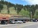 A row of attractive storefronts offering various restaurants and shops against a scenic mountain backdrop at 26212 Center Dr, Kittredge, CO 80457