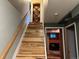 Staircase with wooden stairs and railing leading to downstairs basement area at 26212 Center Dr, Kittredge, CO 80457