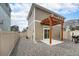 Backyard with wood pergola, concrete patio, gravel ground cover, and fenced yard at 3934 N Quatar Ct, Aurora, CO 80019