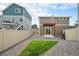 Backyard featuring wood pergola, rock ground cover, and small grassy area at 3934 N Quatar Ct, Aurora, CO 80019