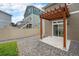 Backyard featuring wood pergola, concrete patio, gravel, and vinyl fence at 3934 N Quatar Ct, Aurora, CO 80019