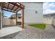 Backyard with wooden pergola, patio, privacy fence and small grassy section at 3934 N Quatar Ct, Aurora, CO 80019