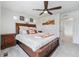 Comfortable bedroom with ceiling fan, wood dresser, and neutral colors providing a relaxing space at 3934 N Quatar Ct, Aurora, CO 80019