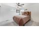 Cozy bedroom with a comfortable bed, soft carpet, and a ceiling fan at 3934 N Quatar Ct, Aurora, CO 80019