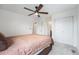 Bright bedroom showcasing a ceiling fan, closet, and neutral tones for a calming atmosphere at 3934 N Quatar Ct, Aurora, CO 80019