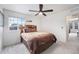 Cozy bedroom featuring a ceiling fan, plush carpet, and a view through the window at 3934 N Quatar Ct, Aurora, CO 80019