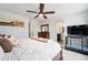 Inviting bedroom with a bathroom, cage, wooden dresser, and ceiling fan for added comfort at 3934 N Quatar Ct, Aurora, CO 80019