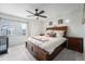 Serene bedroom features bright window, wood bed frame, and neutral walls to relax and unwind at 3934 N Quatar Ct, Aurora, CO 80019