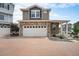 Charming two-story home with a two-car garage, stone accents, and a brick driveway at 3934 N Quatar Ct, Aurora, CO 80019