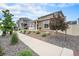 Well-maintained home exterior with lush landscaping and a welcoming sidewalk at 3934 N Quatar Ct, Aurora, CO 80019