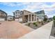Beautiful home exterior with brick driveway, stone accents, and landscaped front yard at 3934 N Quatar Ct, Aurora, CO 80019