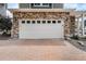 A well maintained garage door, brick accents, and an inviting brick driveway at 3934 N Quatar Ct, Aurora, CO 80019