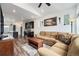 Open-concept living room flows into the kitchen, featuring a comfortable sofa and wood floors at 3934 N Quatar Ct, Aurora, CO 80019