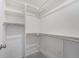 Spacious walk-in closet with shelving and hanging racks for organization and storage of clothing at 3934 N Quatar Ct, Aurora, CO 80019