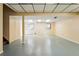 Finished basement with drop ceiling, concrete floors, built-in wall, and windows for light at 466 S Kingston Cir, Aurora, CO 80012