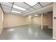 Spacious finished basement area with drop ceiling, concrete floor, natural light, and neutral walls at 466 S Kingston Cir, Aurora, CO 80012