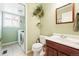 Well-lit bathroom with modern fixtures, a vanity, and a laundry area at 466 S Kingston Cir, Aurora, CO 80012