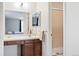 Bathroom vanity with wood cabinets, ample counter space and stand up shower at 466 S Kingston Cir, Aurora, CO 80012