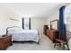 Bright bedroom with floral bedding, wooden furniture, and natural light from two windows at 466 S Kingston Cir, Aurora, CO 80012