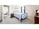 Comfortable bedroom featuring a floral bedspread and view into another room at 466 S Kingston Cir, Aurora, CO 80012