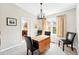 Bright dining room showcasing the dining table with chairs, neutral walls, and access to kitchen at 466 S Kingston Cir, Aurora, CO 80012