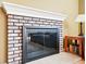 Close-up of a brick fireplace in a cozy living room setting at 466 S Kingston Cir, Aurora, CO 80012