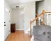 Inviting foyer with hardwood floors, a white front door, and staircase leading to the upper level at 466 S Kingston Cir, Aurora, CO 80012